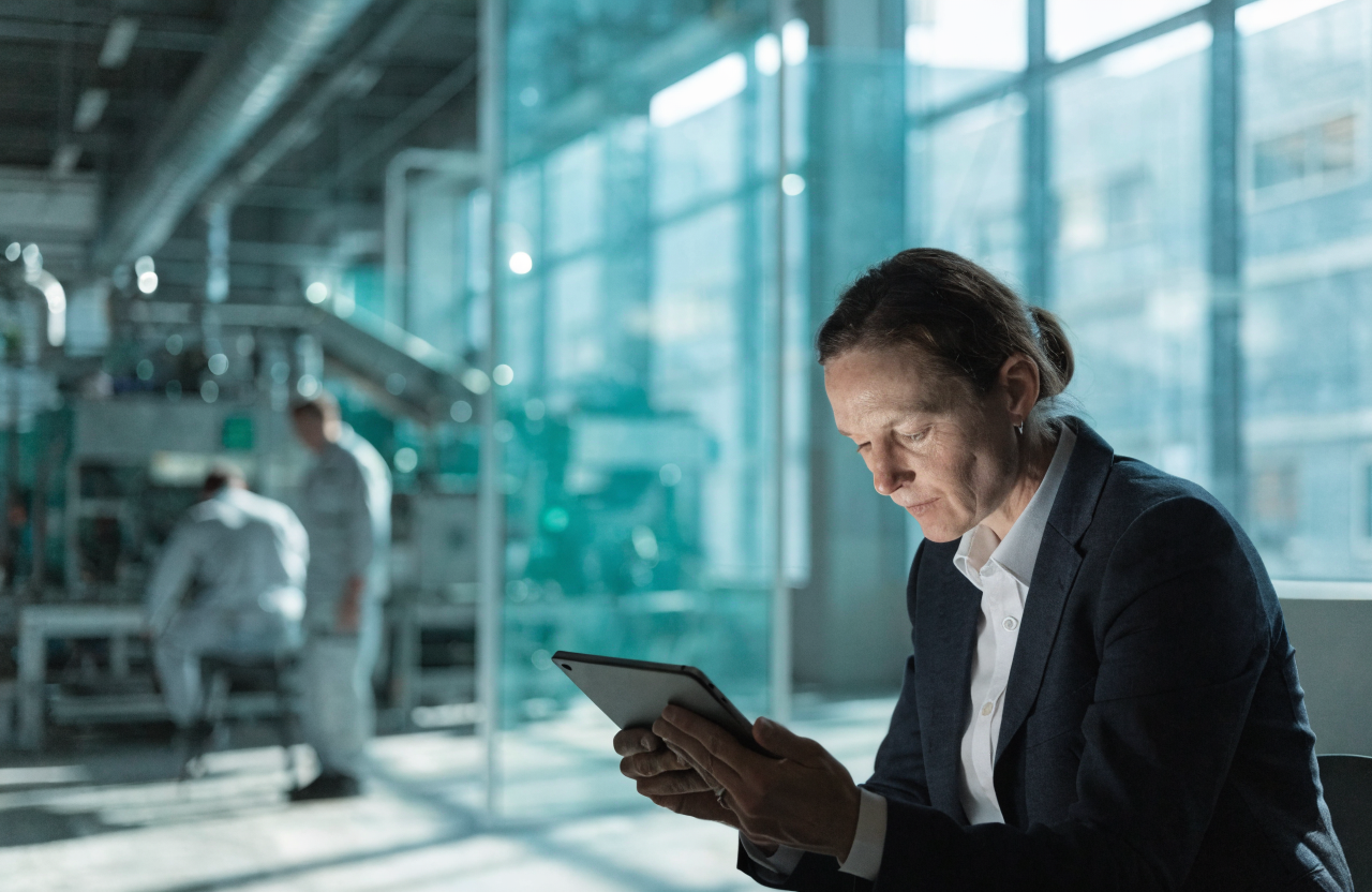 Auditor reviewing quality compliance in a manufacturing facility